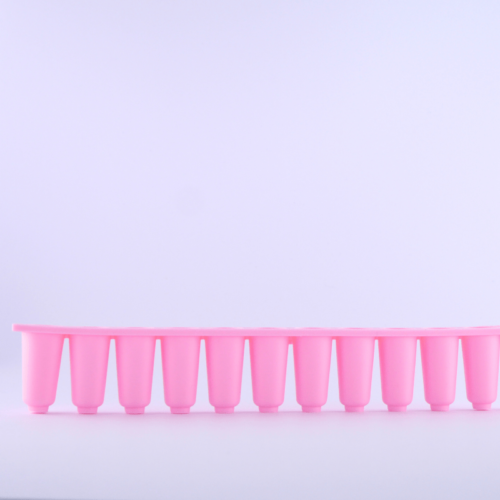 The side view of these gorgeous pink pessary wells of the 12-well silicone pessary mould to make your own vaginal pessaries at home.