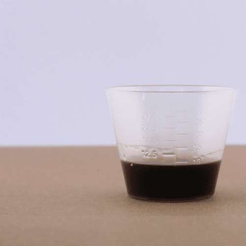 Herbal medicine measuring cup with UTI and vaginal infection curing herbs in it.