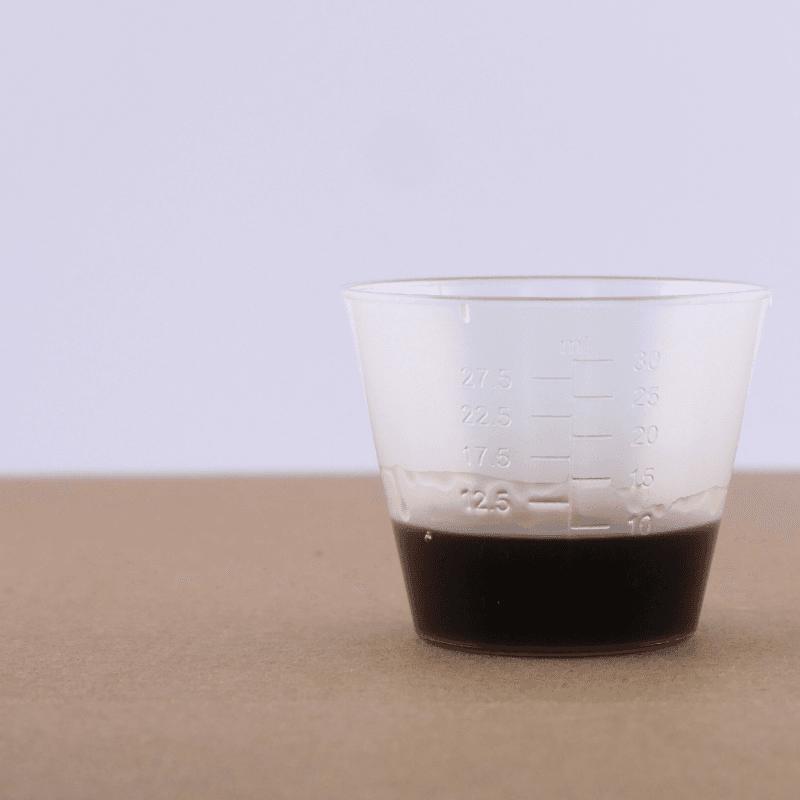 Herbal medicine measuring cup with UTI and vaginal infection curing herbs in it.