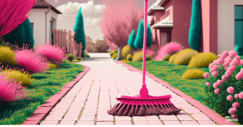 A pink broom stands alone on a suburban pathway, ready to do a pathway clean up