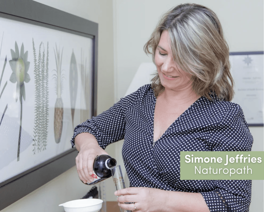 Simone Jeffries in her clinic pouring herbal medicine.