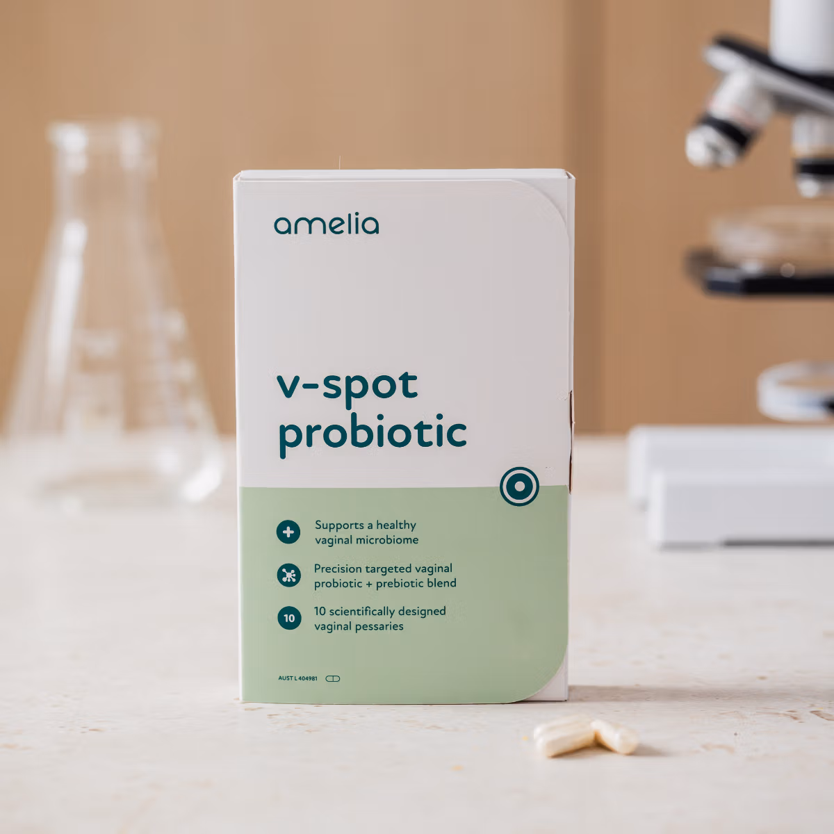 Amelia V-Spot Probiotic box on a laboratory bench with a microscope and flasks