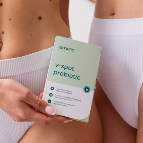 Two women hold the V-spot vaginal probiotic box