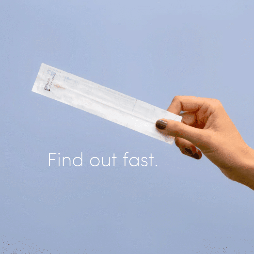 A hand holds a Juno vaginal microbiome swab ready to find out what's living in her vagina