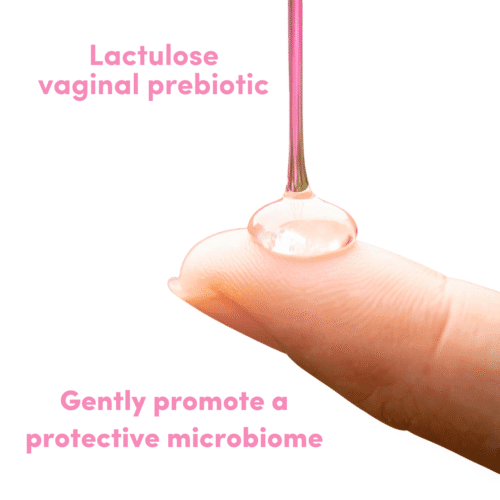 A fingertip holds a stream of clear liquid lactulose used for lactobacillus iners clearance in the vagina
