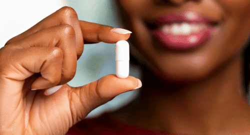 A woman holds up a boric acid capsule she thinks is going to help her BV
