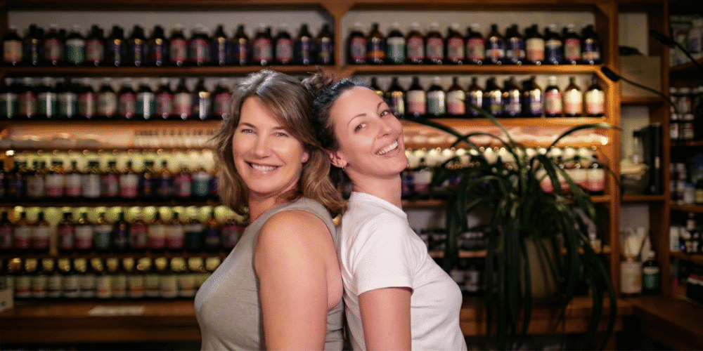 Jessica Lloyd and Simone Jeffries stand back to back in the naturopathic dispensary