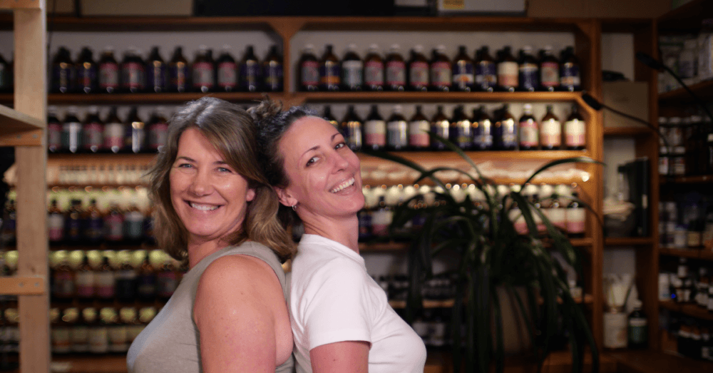 Jessica Lloyd and Simone Jeffries stand back to back in the naturopathic dispensary